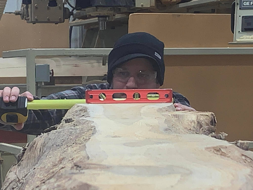 armstrong-creek-company-measuring-log-before-cut armstrong-creek-company-measuring-log-before-cut